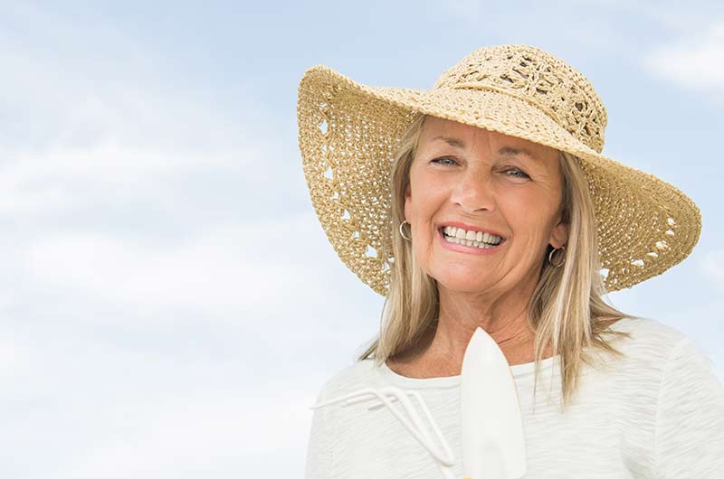 dental-patient-seniorwomanholdinggardeningequipment dental-patient-seniorwomanholdinggardeningequipment